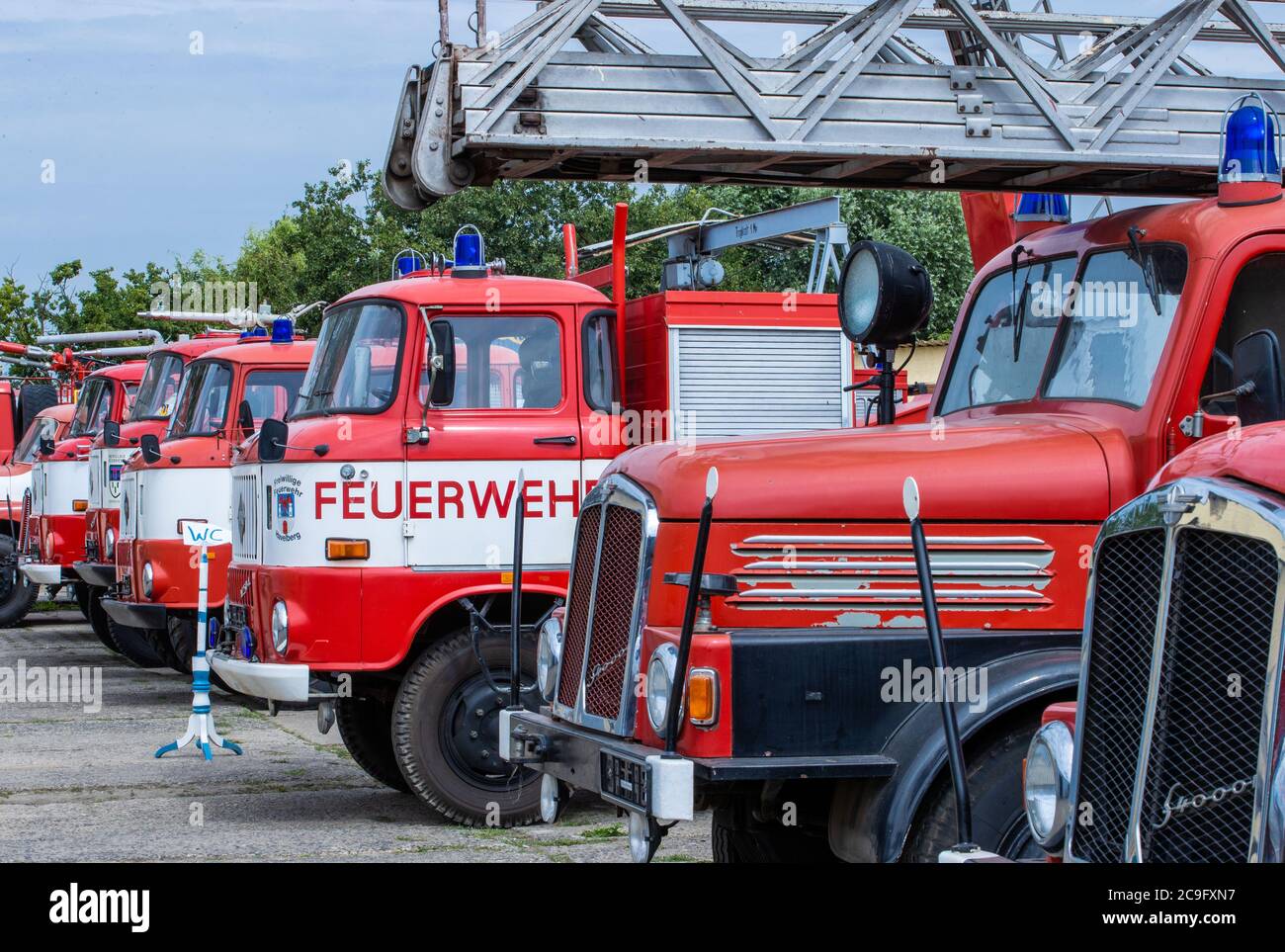 Beuster, Germany. 24th July, 2020. Fire engines are on display on the exhibition grounds during the blue light days in the blue light museum Beuster. Despite corona protection measures, the blue light museum on the Elbe celebrates its museum week and shows the collection of historical fire brigade, police and military technology. Credit: Jens Büttner/dpa-Zentralbild/ZB/dpa/Alamy Live News Stock Photo