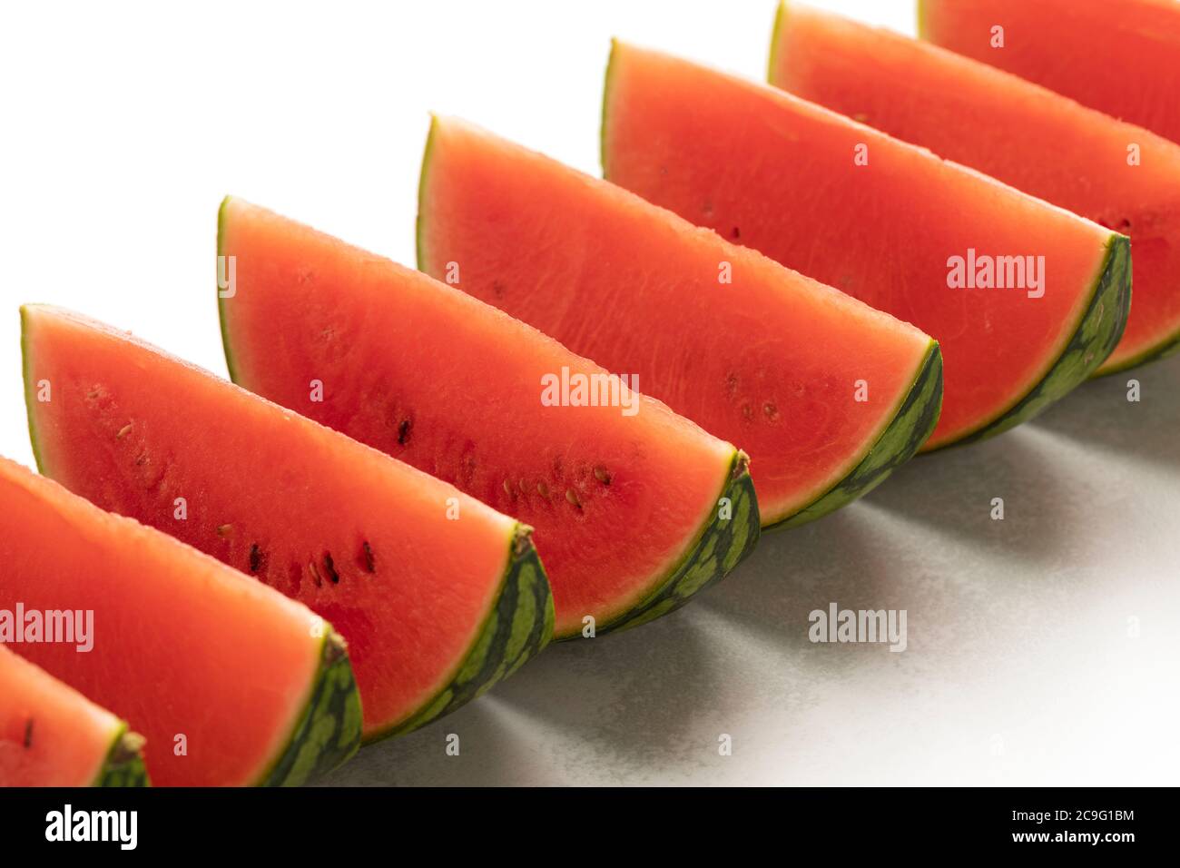 Fresh ripe red watermelon wedges in a row close up Stock Photo