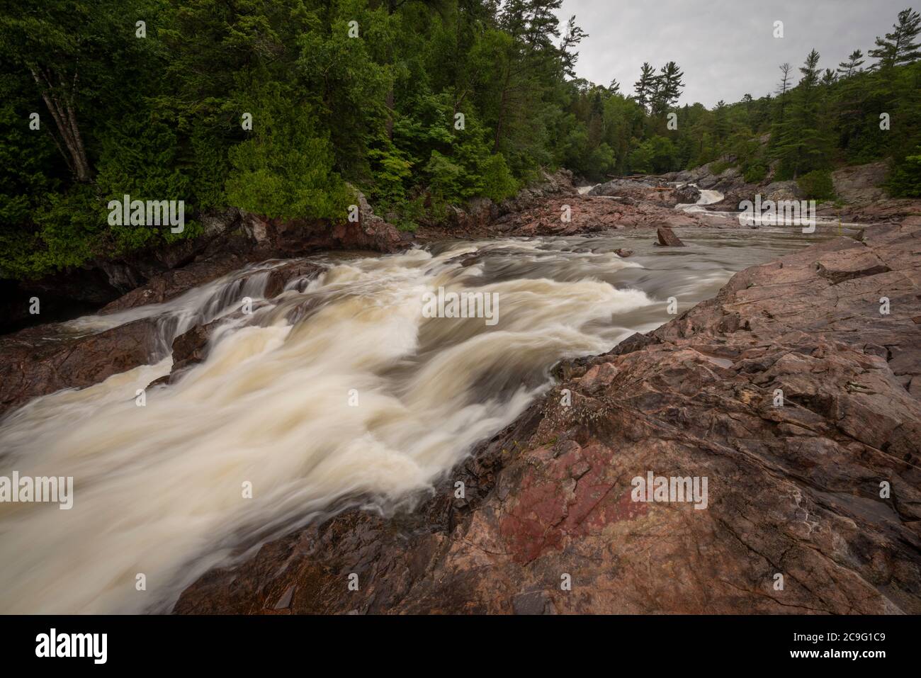 A rushing river, brown with tannins, in Ontario's northland flows down