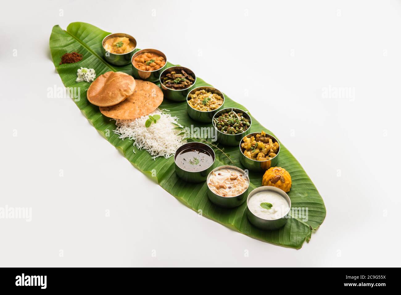 Traditional South Indian Meal or food served on big banana leaf, Food platter or complete thali.  selective focus Stock Photo