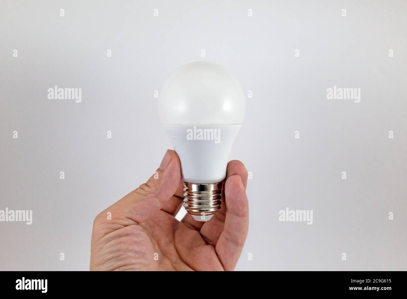 Man hand holding white light bulb isolated on white background Stock ...
