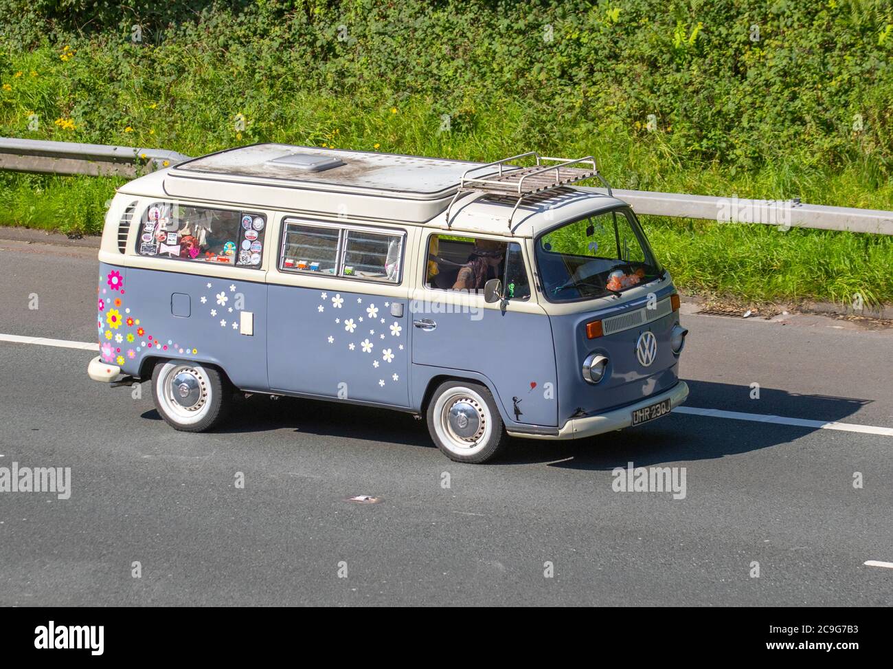 1971 70s seventies VW Volkswagen Microbus 8 Seater; Touring Caravans and Motorhomes, campervans on Britain's roads, RV leisure vehicle, family holidays, caravanette vacations, caravan holiday, van conversions, autohome, 1960s Flower Power, motorhome on the road UK Stock Photo