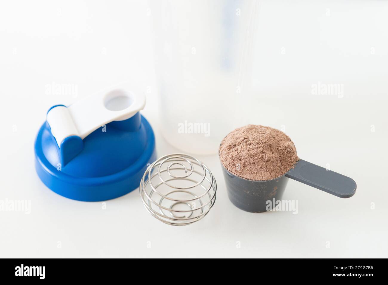 Preparation of a whey protein shake to help with muscle building from a workout. Exercise, health, resistance training Stock Photo