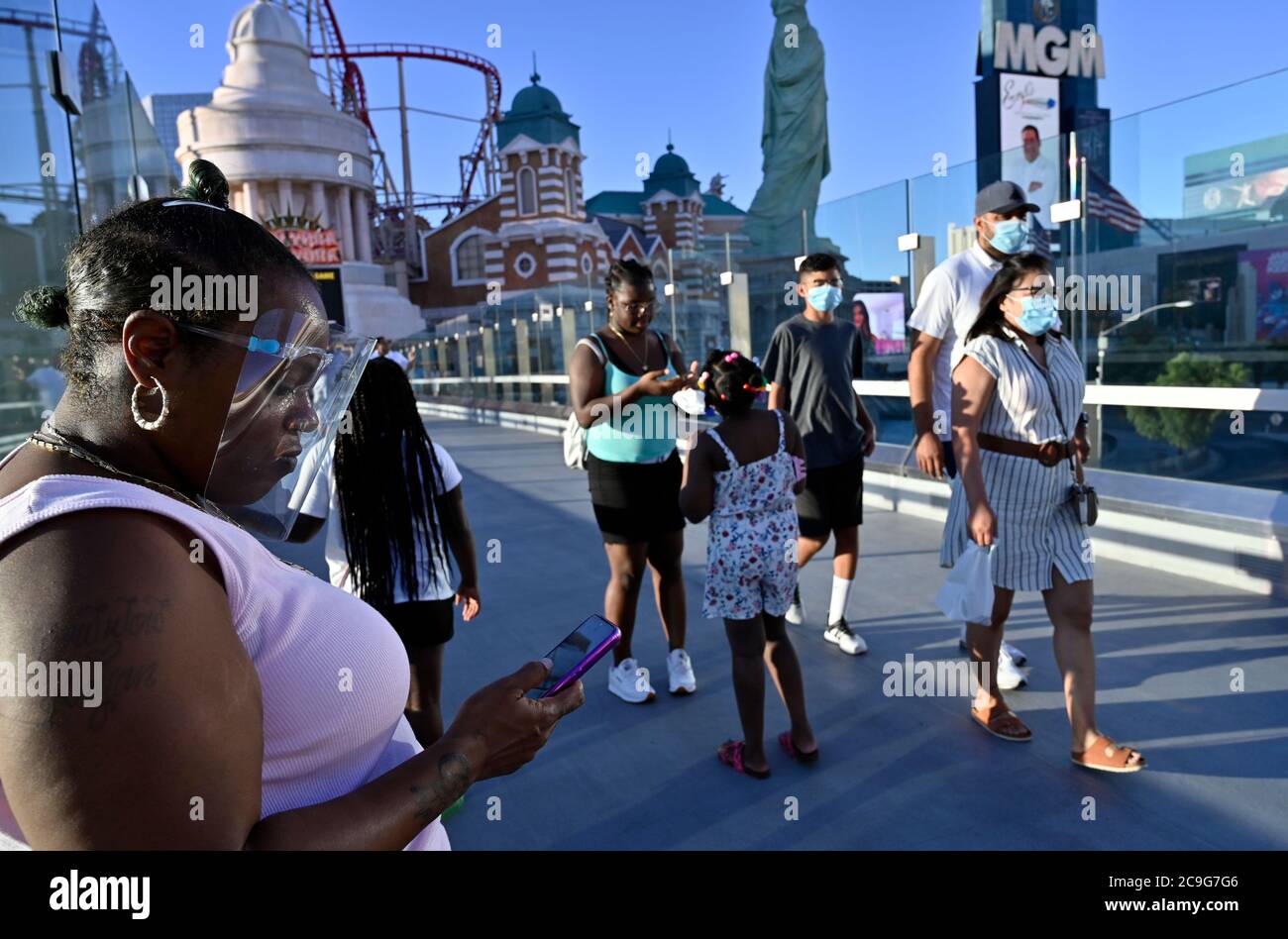 Las Vegas, Nevada, USA. 30th July, 2020. People wear face coverings as they stroll the Las Vegas Strip on July 30, 2020 in Las Vegas, Nevada. The state has a mandatory face covering policy in effect for anyone in any public space. Credit: David Becker/ZUMA Wire/Alamy Live News Stock Photo