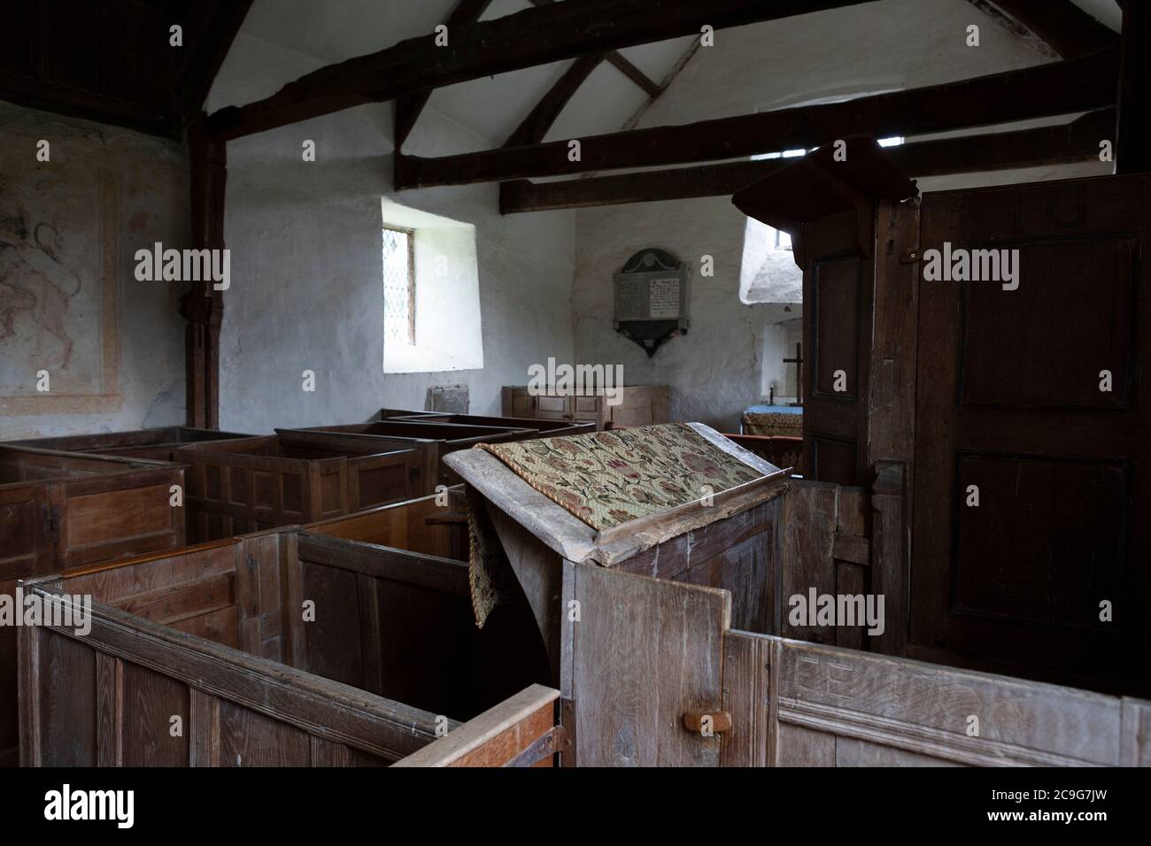 Interior of the ancient St Cewydd's Church, Disserth, mid Wales, with old pews Stock Photo