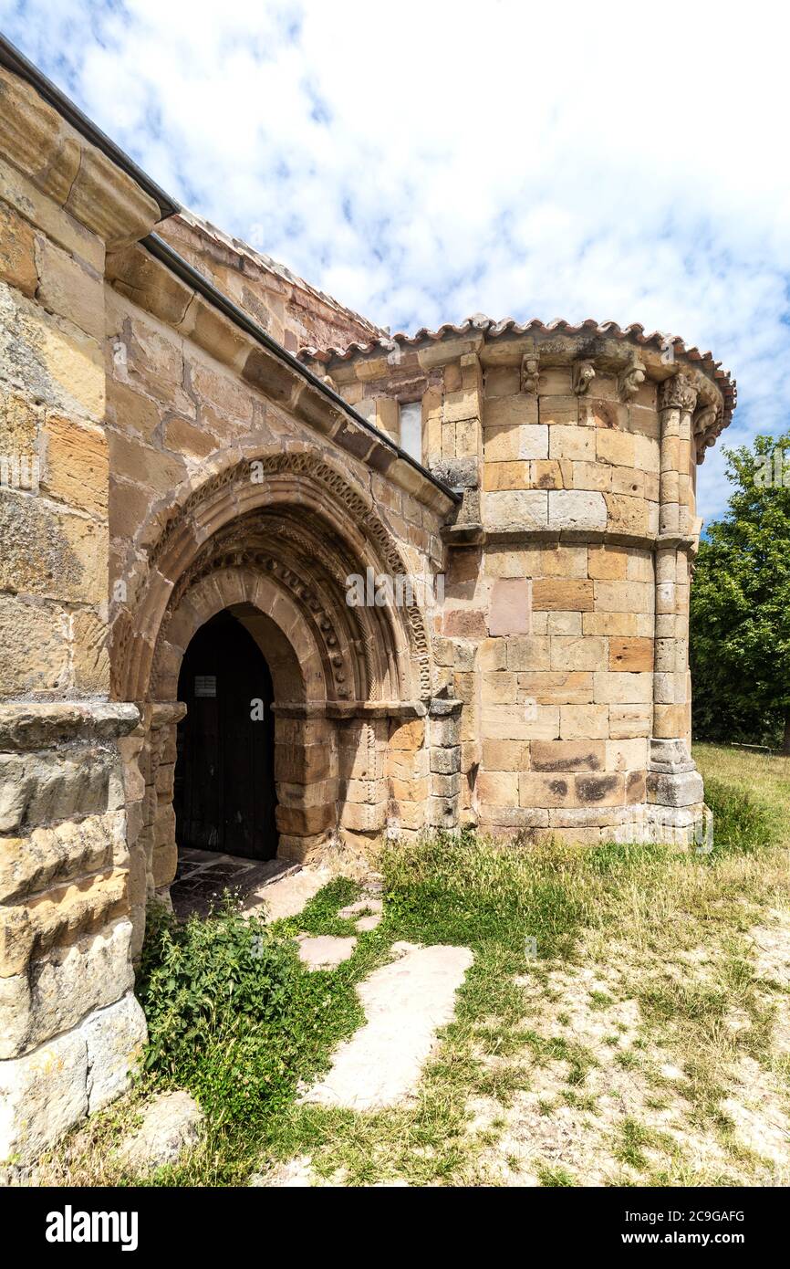Romanesque apse and main door of church in Villacantid, Cantabri Stock Photo