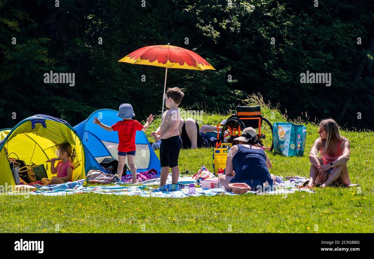 Bolton Abbey, Skipton, UK. 31st July, 2020. People sunbathing and frolicking in the sweltering heat today in the grounds of Bolton Abbey. Credit: ernesto rogata/Alamy Live News Stock Photo