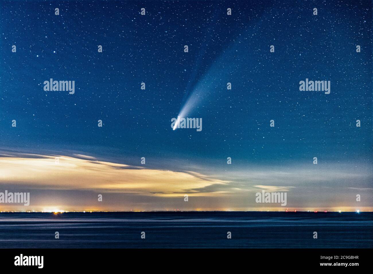 Comet Neowise Streaking Through The Sky Above The Ocean After Sunset