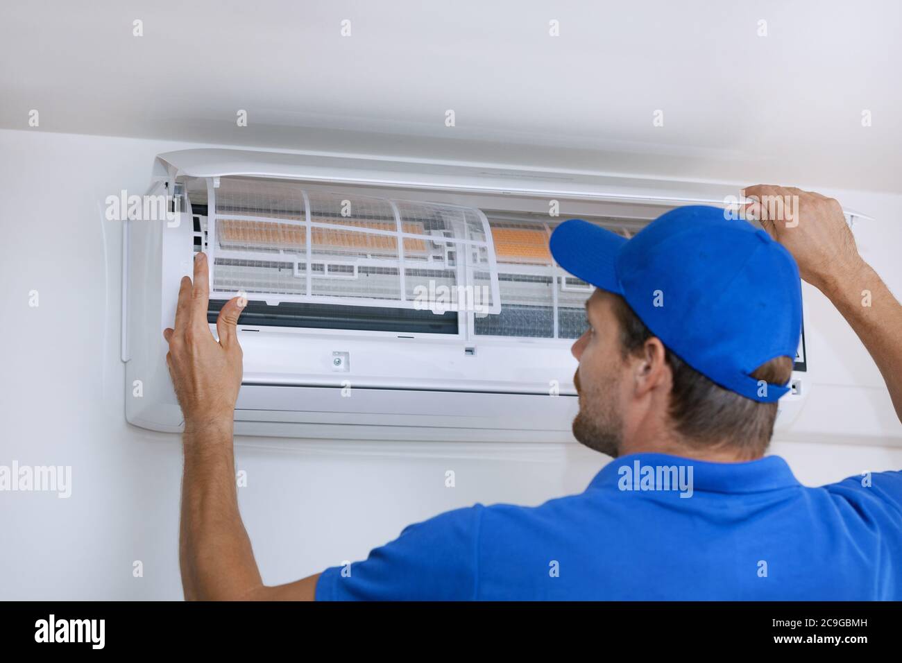 air conditioner maintenance and repair service. hvac technician working Stock Photo
