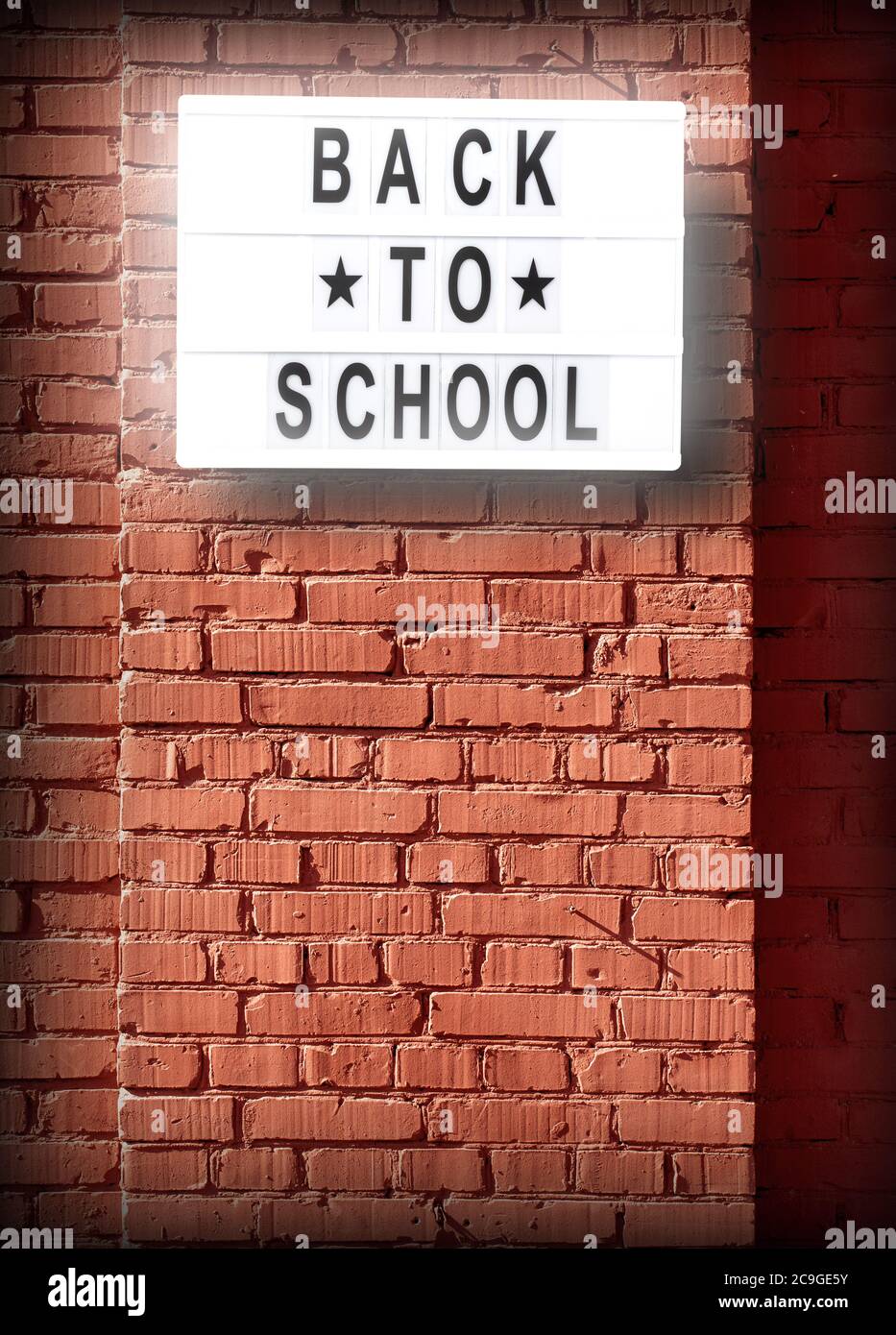 back to school letterboard text - background with copy space on red bricks wall Stock Photo