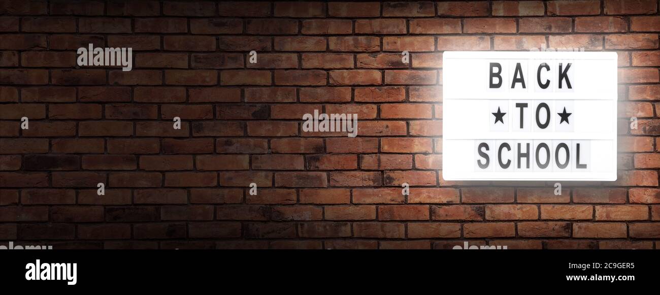 back to school letterboard text -  background with copy space on red bricks wall Stock Photo