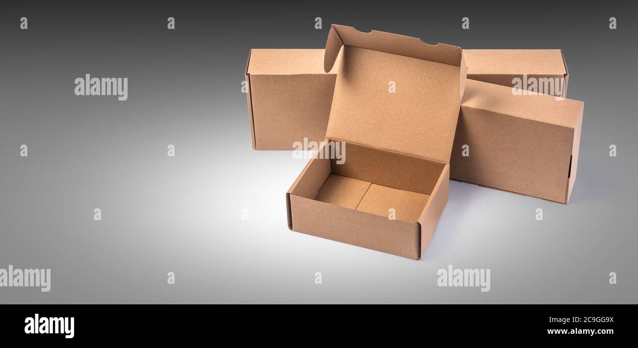 closing a stack of cardboard boxes on a grey background with clipping path Stock Photo