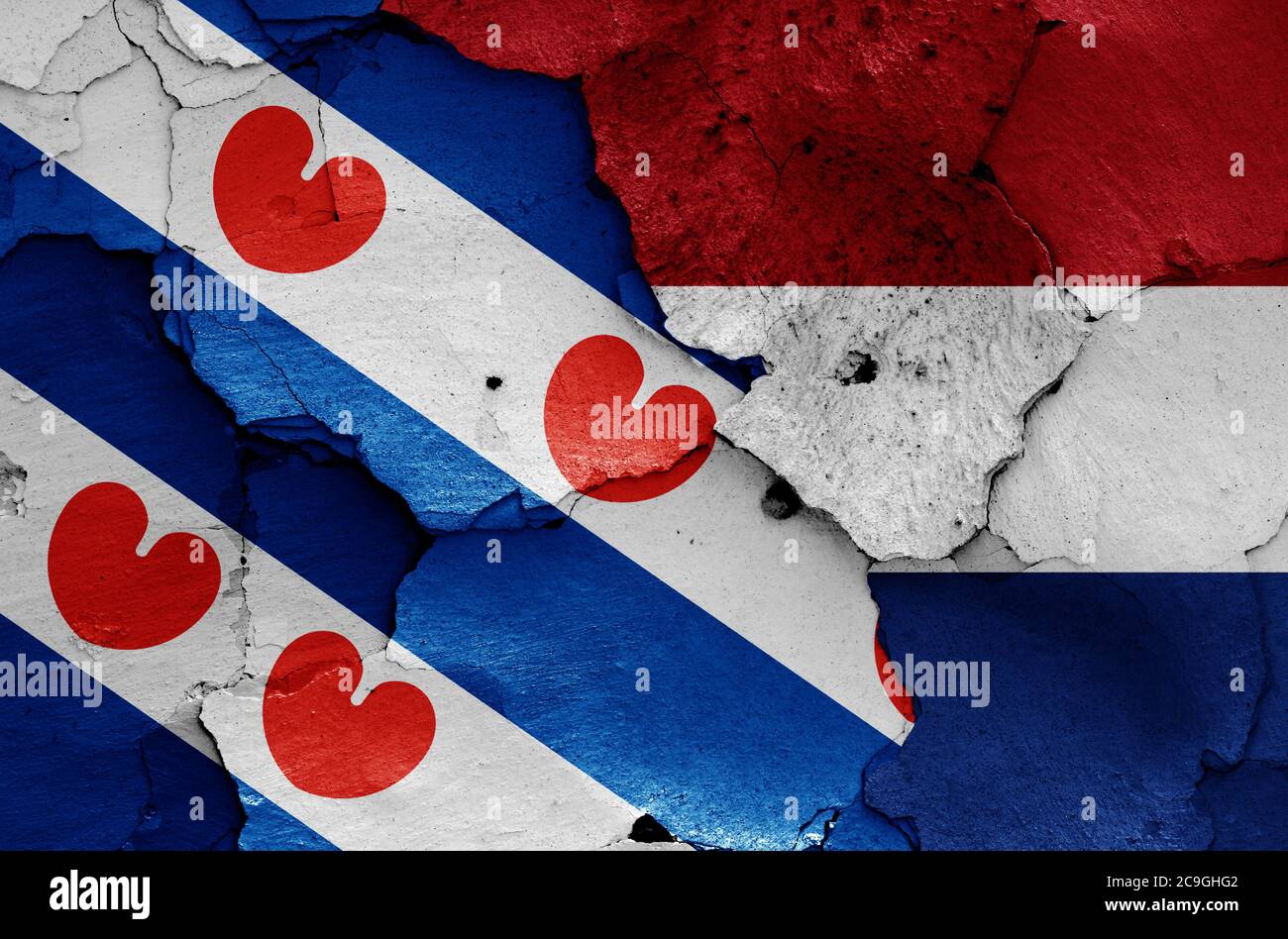 flags of Friesland and Netherlands painted on cracked wall Stock Photo