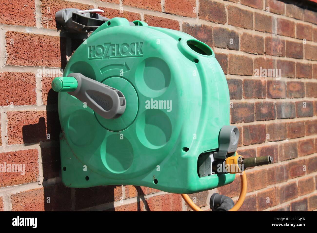 https://c8.alamy.com/comp/2C9GJY6/hose-reel-tidy-mounted-outside-on-domestic-wall-2C9GJY6.jpg