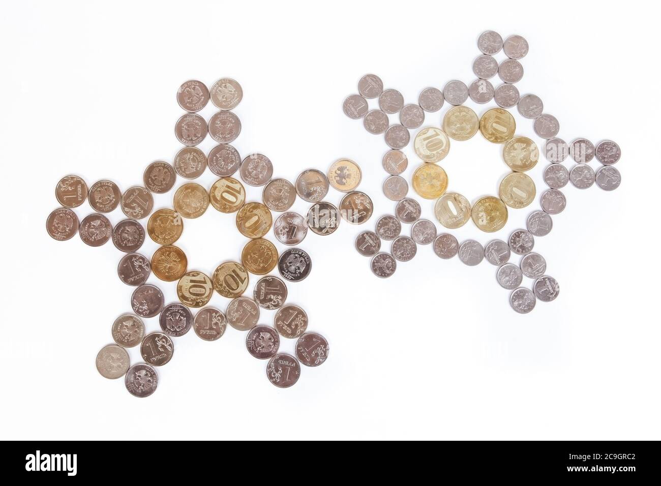 Coins laid out in the shape of a clock on a white background Stock Photo