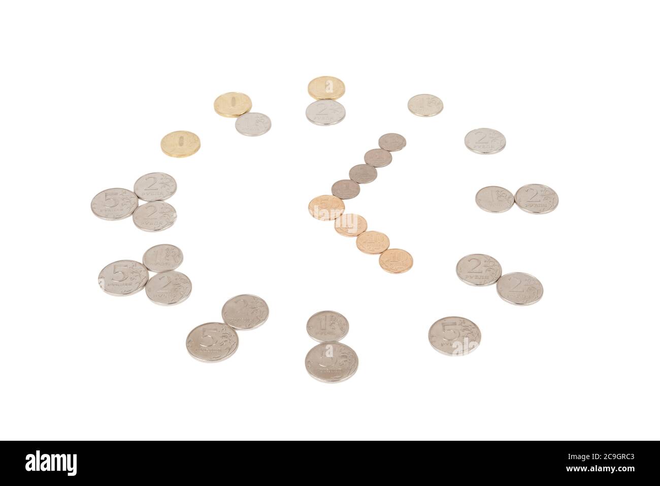 Coins laid out in the shape of a clock on a white background Stock Photo