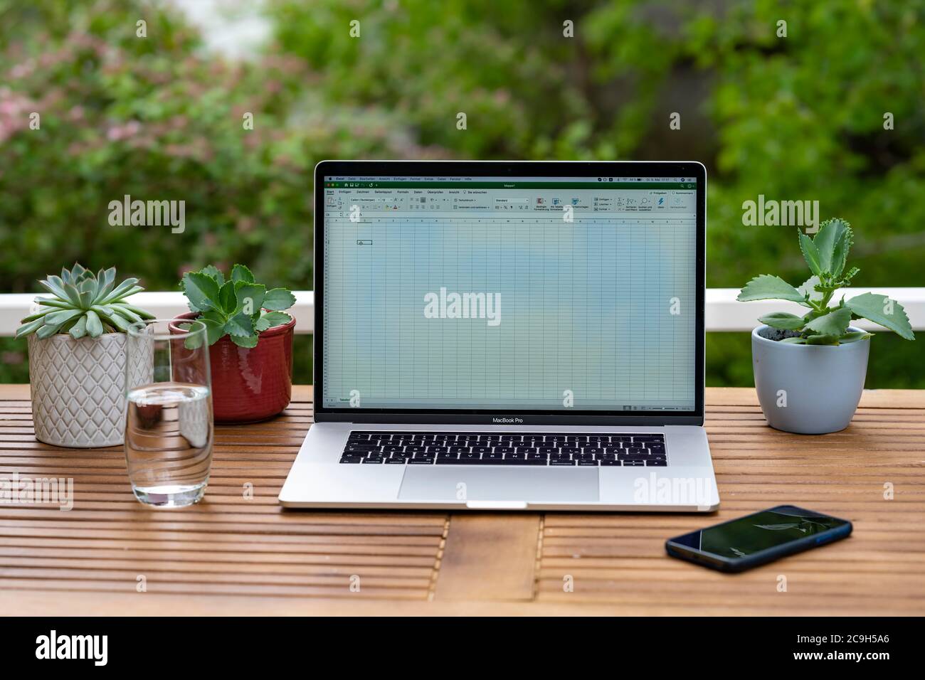 Home office with laptop, Apple MacBook Pro with iPhone X at the desk, with Microsoft Excel open, Germany Stock Photo