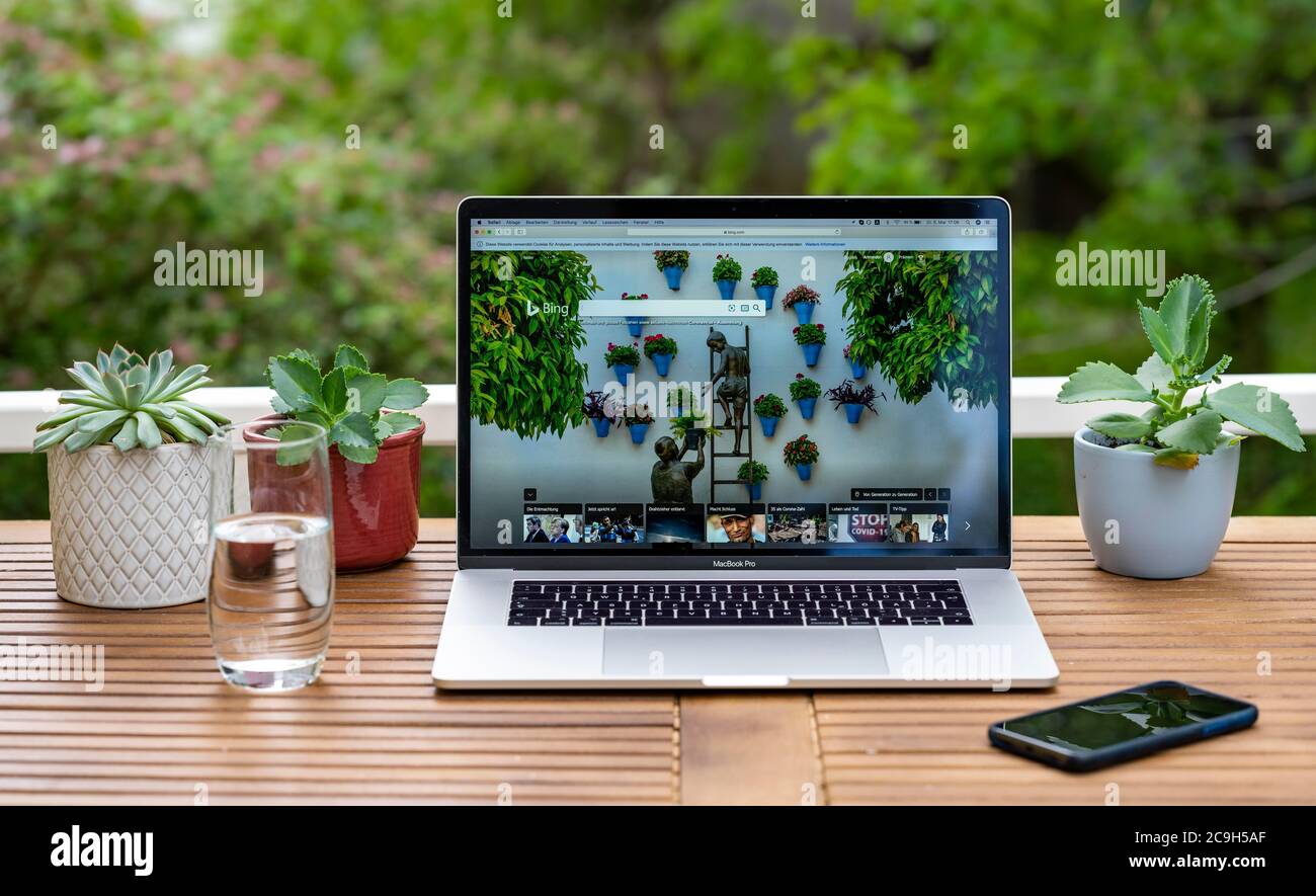 Home office with laptop, Apple MacBook Pro with iPhone X at the desk