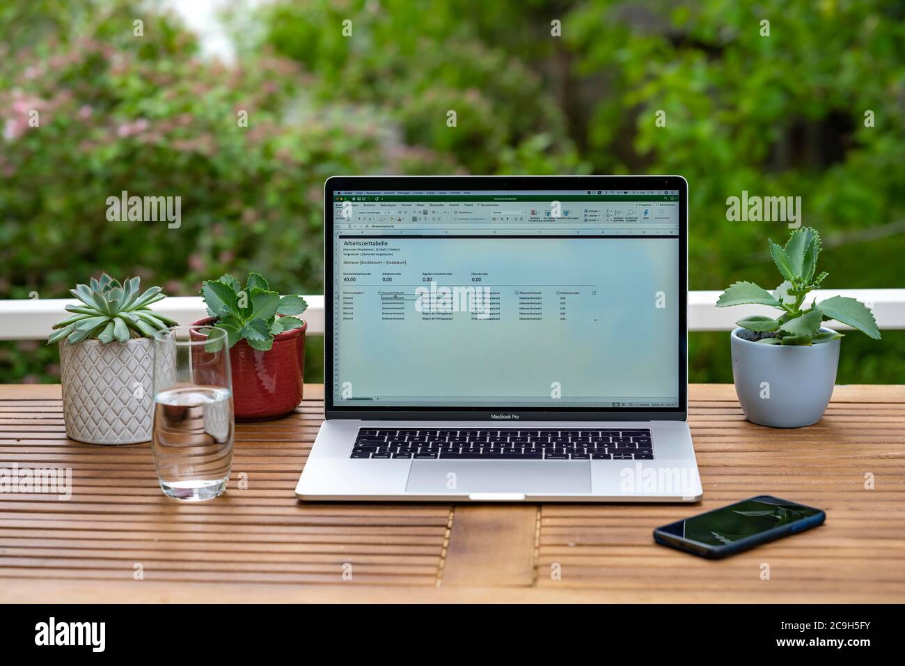 Home office with laptop, Apple MacBook Pro with iPhone X at the desk, with  open Microsoft Excel application with table for working hours, Germany  Stock Photo - Alamy