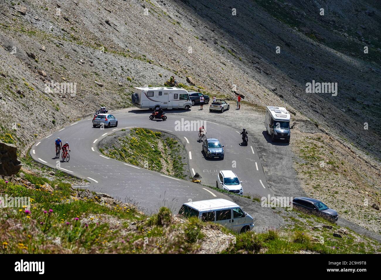 Varied vehicles on a bend on the Galibier Pass, in the French Alps Stock Photo