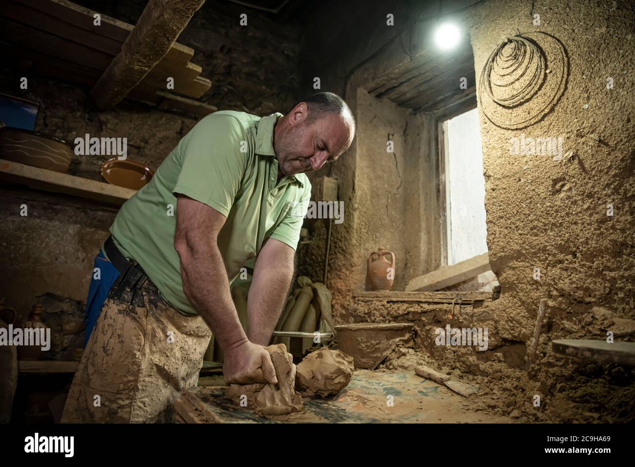 Sculptor man creating sculpture from clay in Process of
