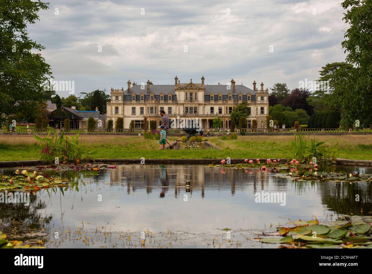 A man and boy explore the partly overgrown grounds of National Trust
