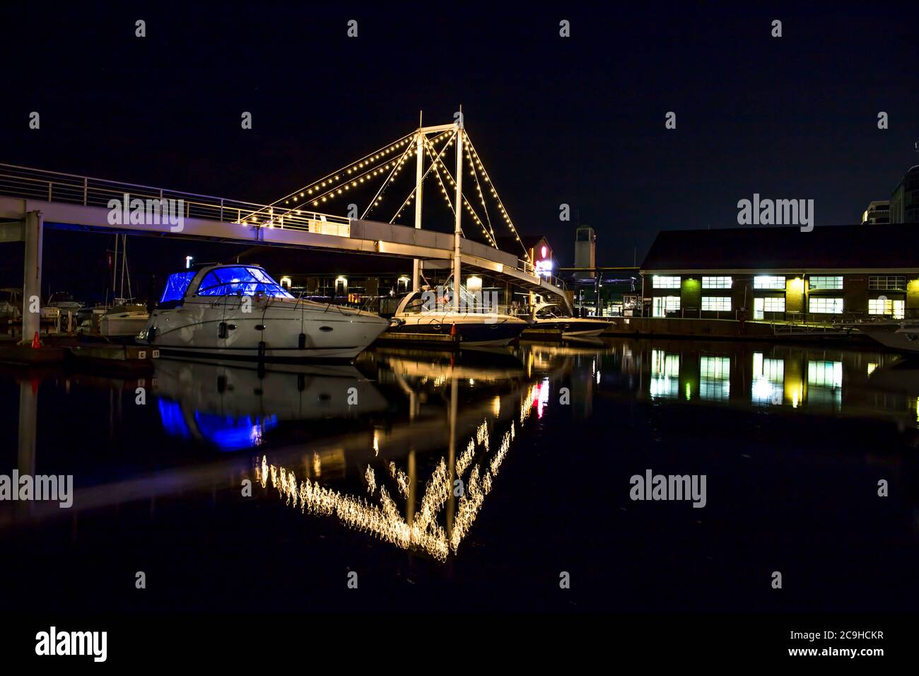 yachts stay in doc. Marine harbour. Night lights on the bridge in