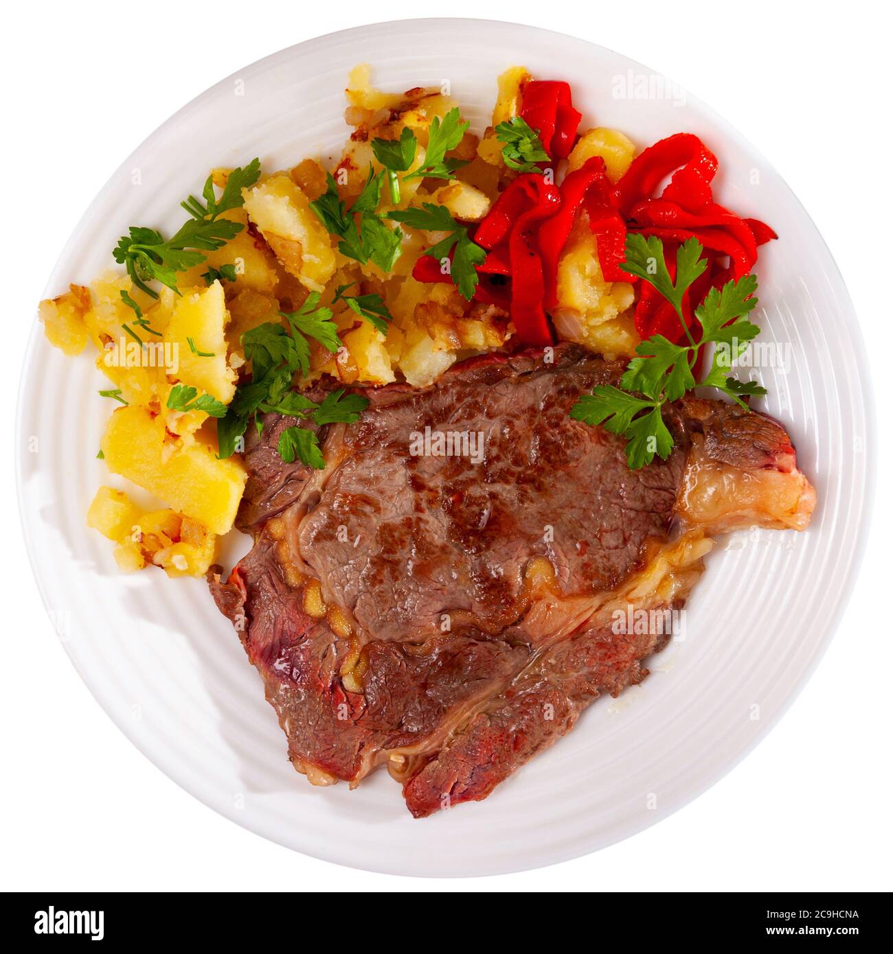 Fried veal cutlet with roasted vegetable garnish of potato and pepper