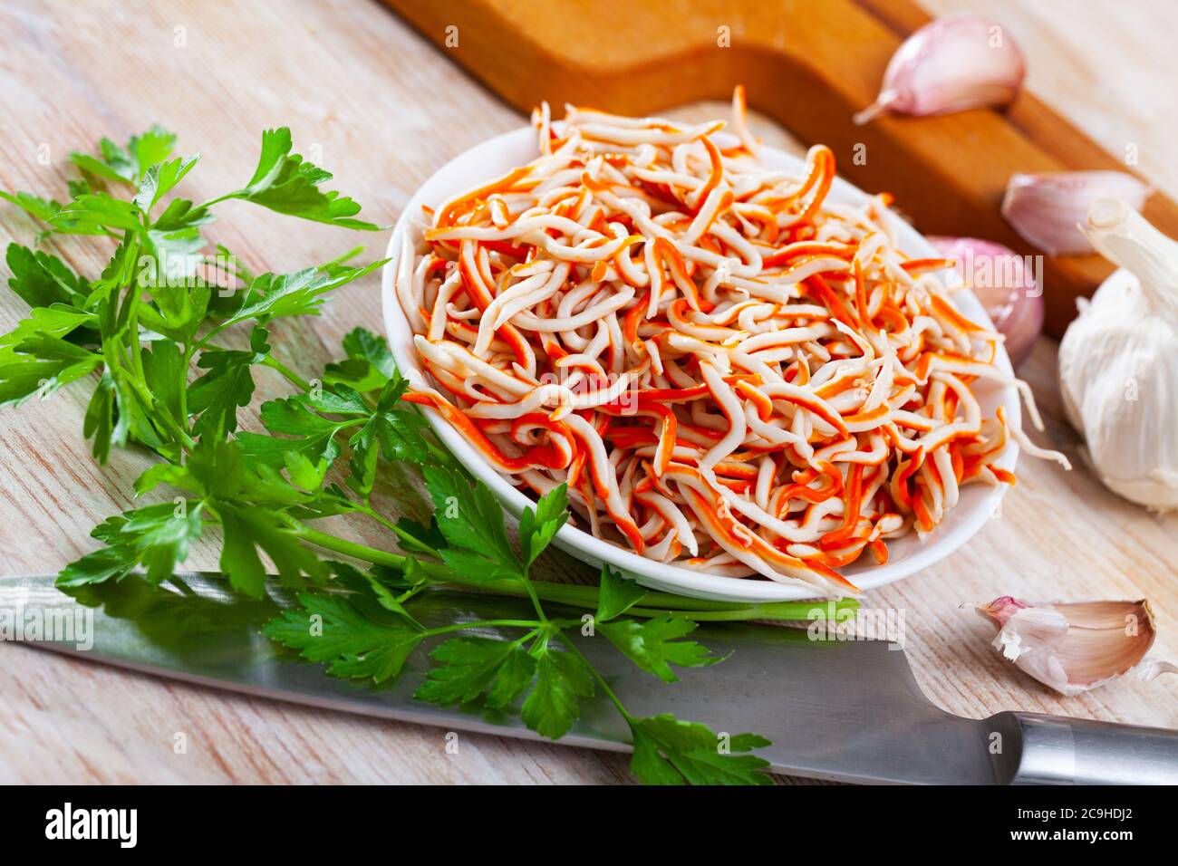 Typical for Spain seafood tapa Rallado de Mar made of grated surimi decorated with fresh parsley Stock Photo