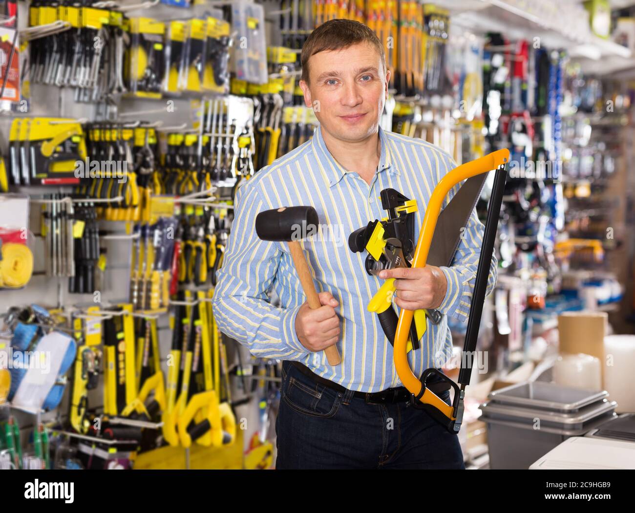 Cheerful man various tools hi-res stock photography and images - Alamy