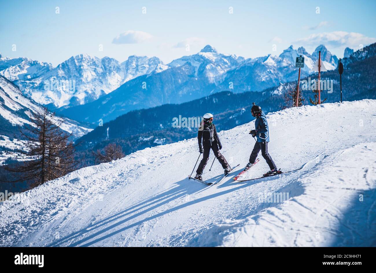 Skiing couple in the Dolomites, Italy Stock Photo