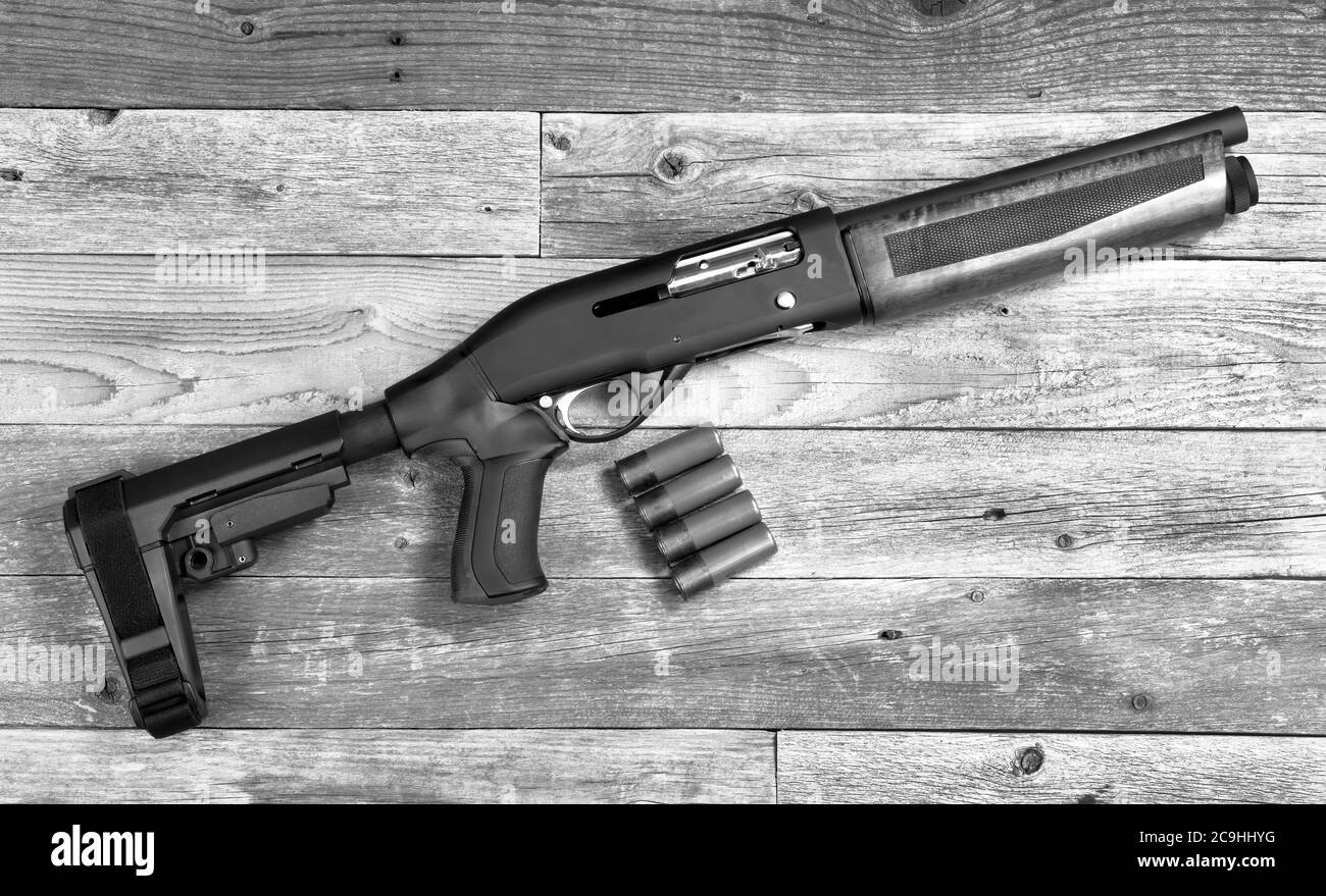 Home security 12 gauge short barrel semi- auto firearm/ shotgun in black and white. Stock Photo