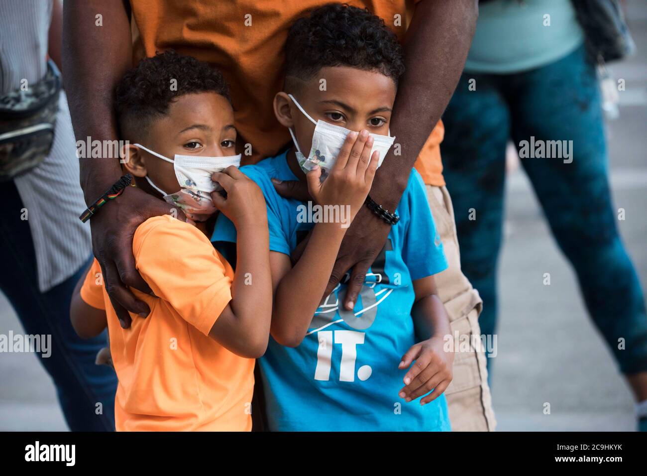 July 29, 2020, Gresham, OREGON, USA: GERMAINE FLENTROY, rests his hands on his two sons GEREME (cq) (left, in orange t-shirt), age 4, and GERMAN (cq), right, age 6, while listening to newest Gresham City Councilor VINCE JONES-DIXON address the crowd during the Black Lives Matter Peaceful Family Rally at Gresham City Hall in Oregon on Wednesday, July 29, 2020. JONES-DIXON is first Black man to serve as a City Councilor and was appointed on July 21st. Gresham's City Council voted on Monday, July 20th to raise the Black Lives Matter flag at City Hall and came under attack from the Multnomah Coun Stock Photo