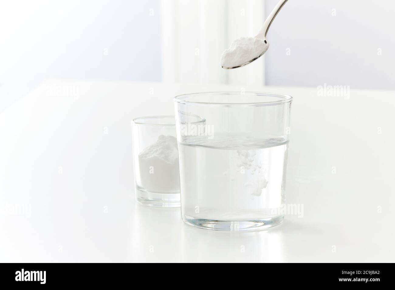 Baking soda dissolving in water, studio shot Stock Photo Alamy