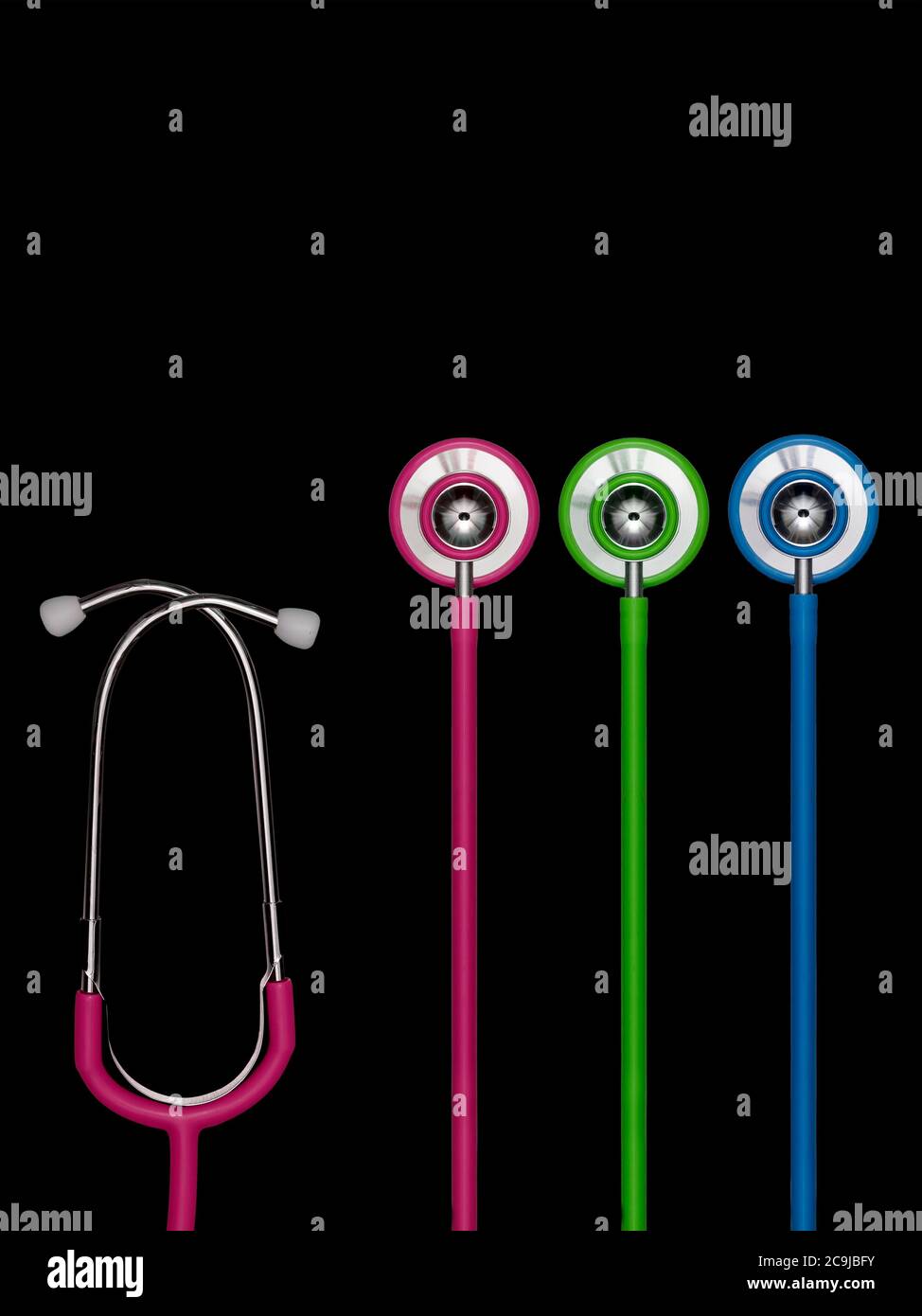 Stethoscopes in a row against a black background. Stock Photo