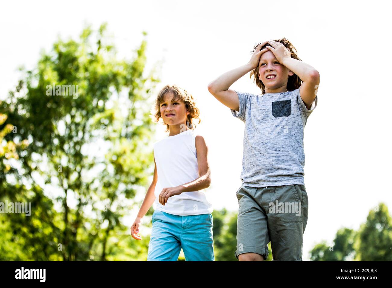 Boys walking in park. Stock Photo