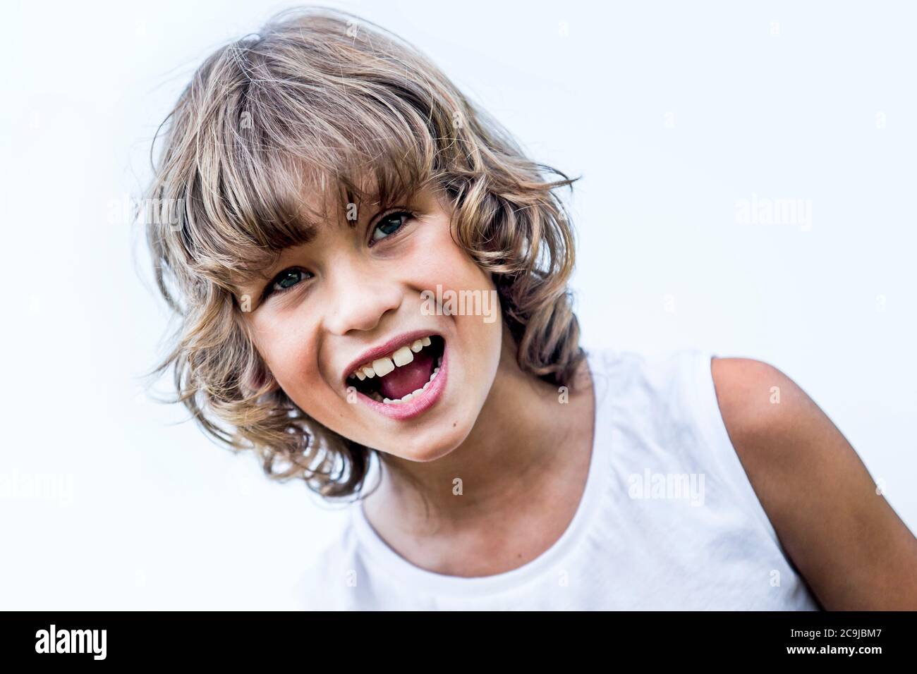 Boy with blonde hair shouting in park. Stock Photo