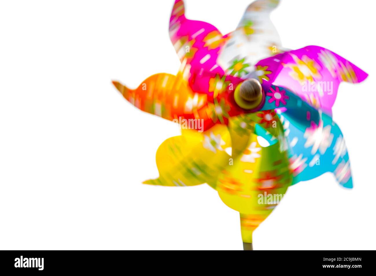 Multi coloured paper windmill in motion, close-up. Stock Photo