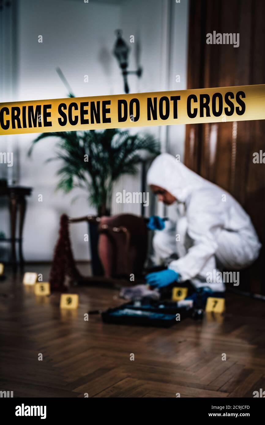 Crime scene. Forensics expert collecting evidence from a crime scene(04)