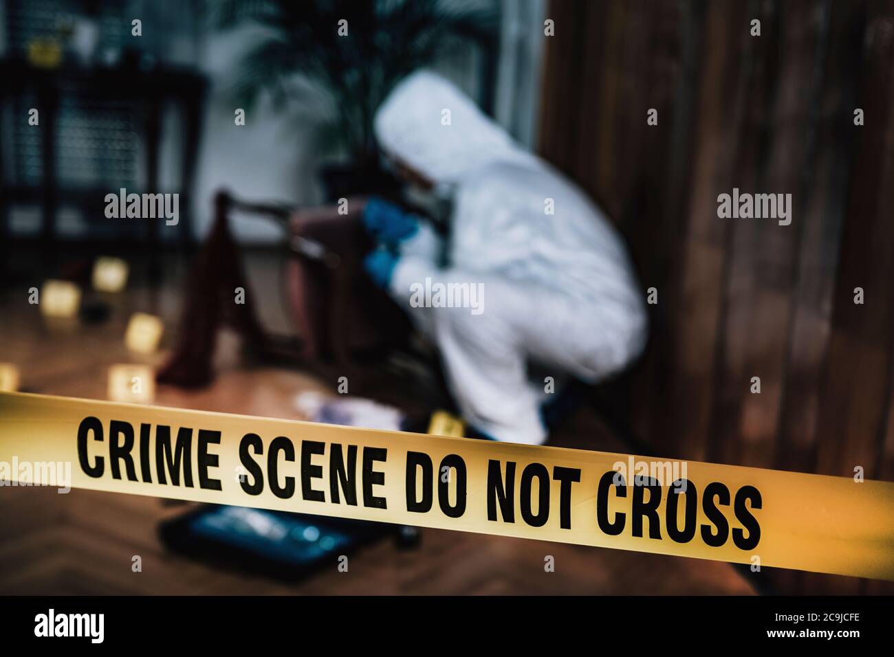 Crime scene. Forensics expert collecting evidence from a crime scene ...