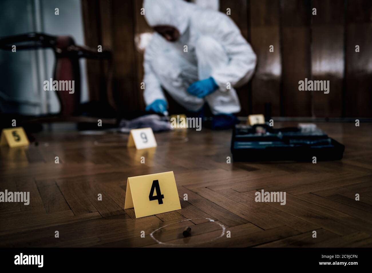 Crime scene. Forensics expert collecting blood samples from a crime