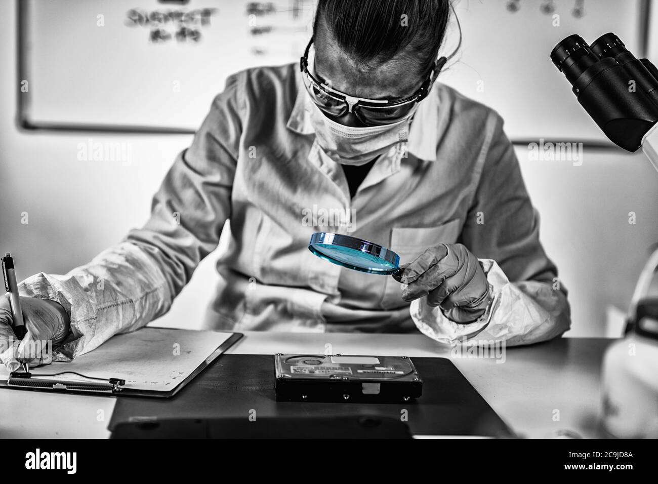 Digital forensic science. Police forensic analyst examining computer ...