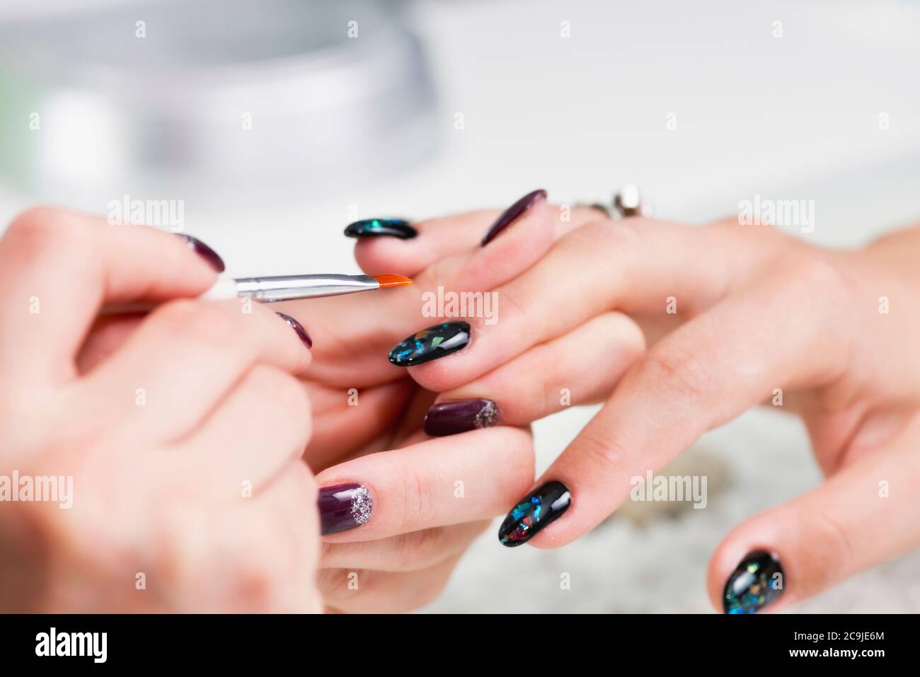 Painting fingernails in nail salon. Stock Photo