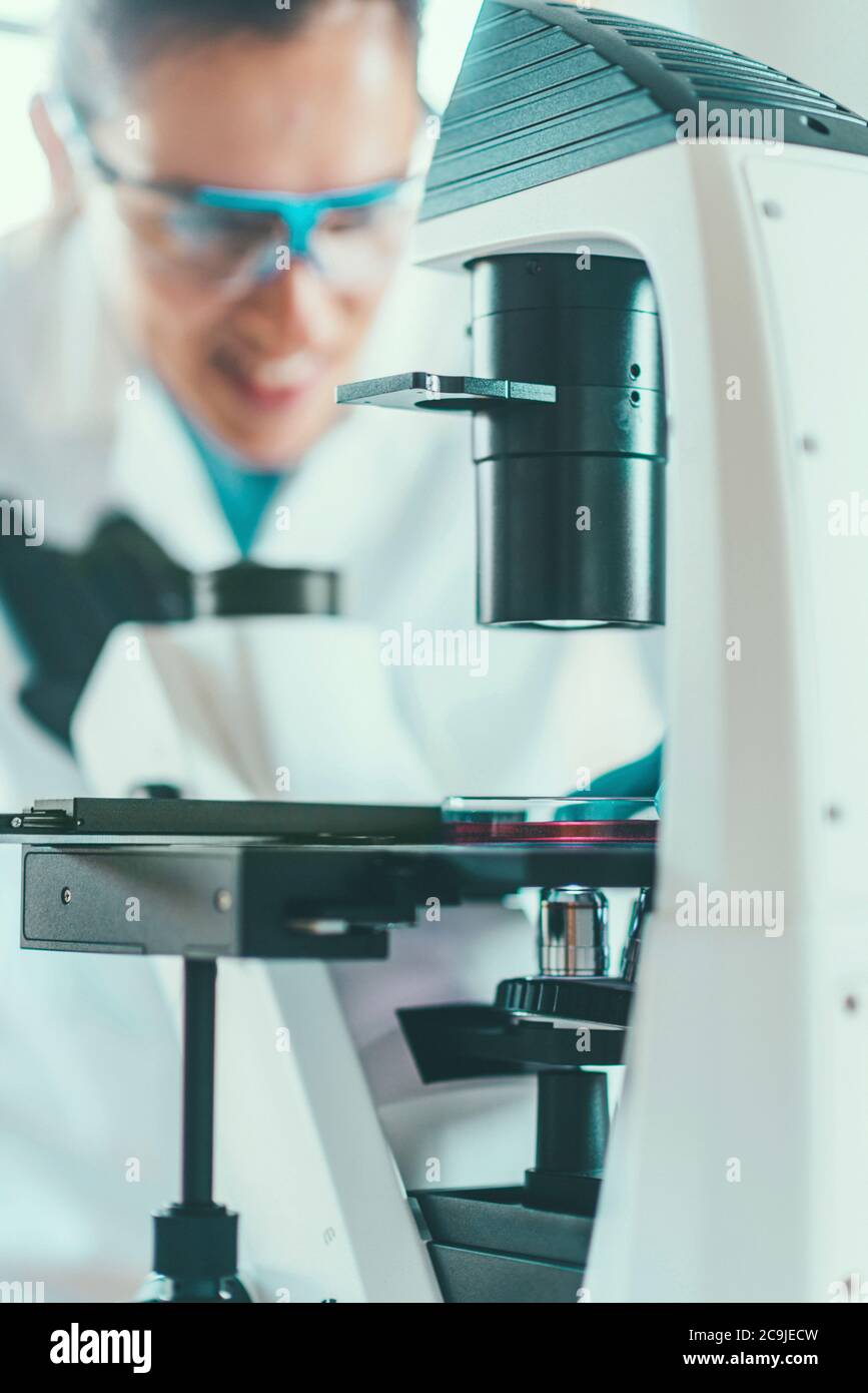 Female chemist or lab technician researching samples in laboratory. Stock Photo