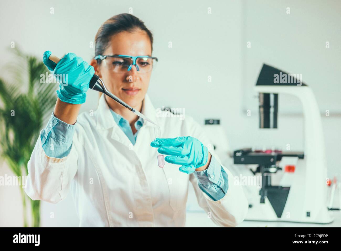 Laboratory technician with micropipette. Stock Photo
