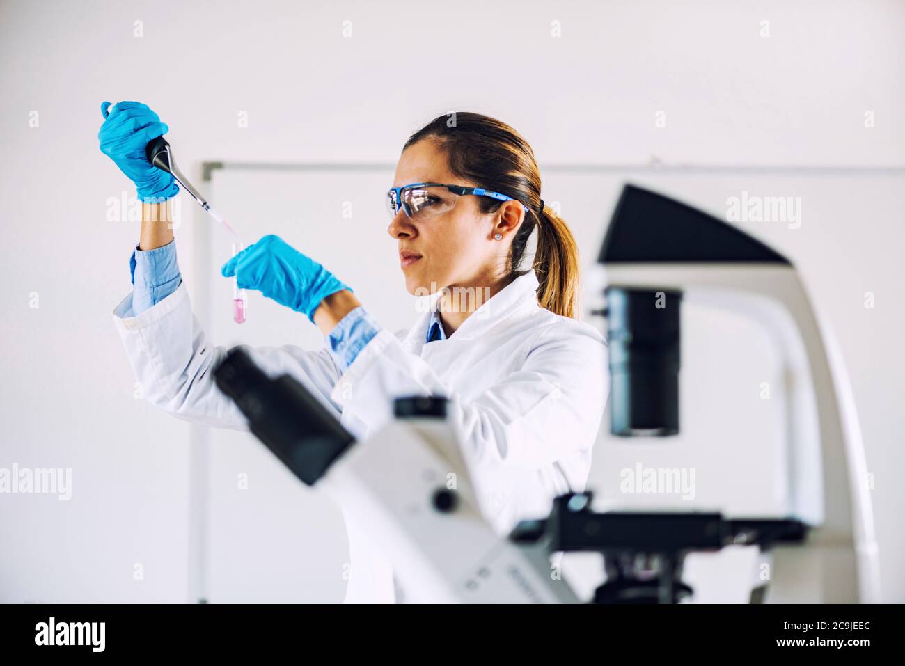 Young scientist working in her lab. Stock Photo