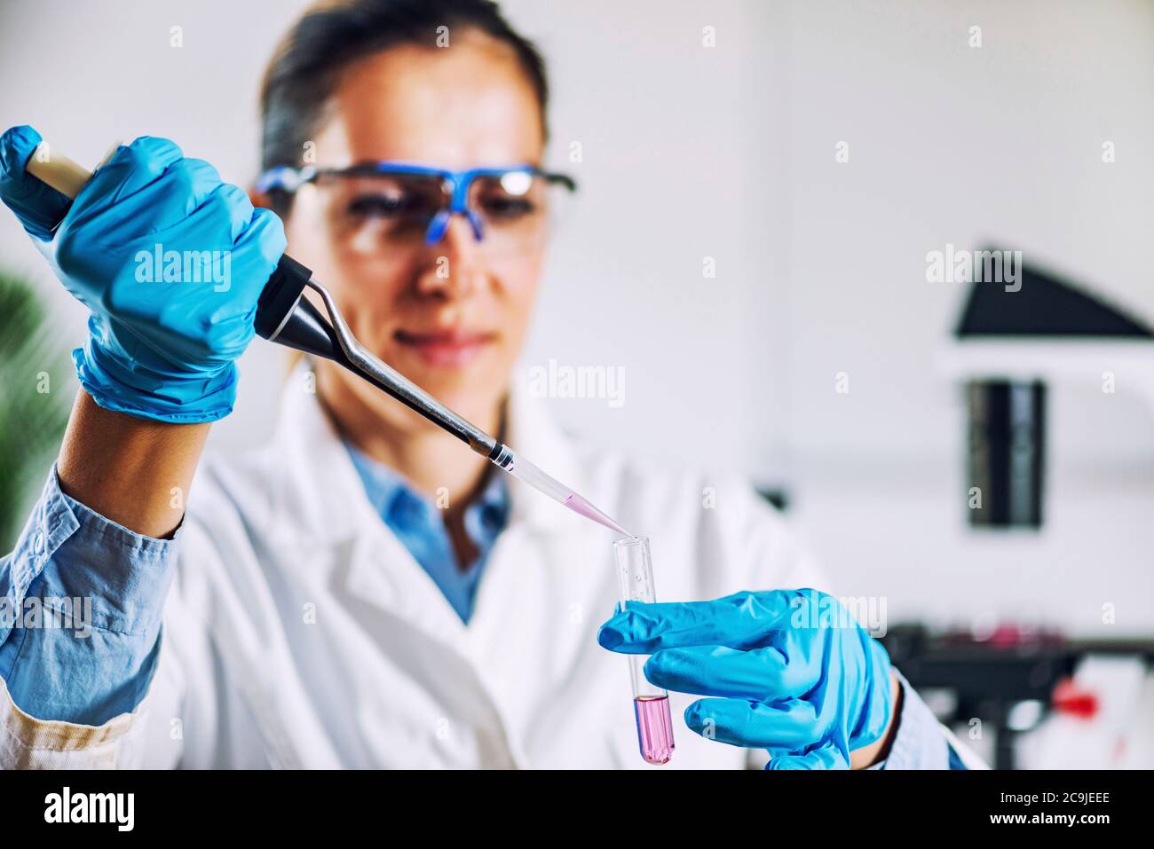 Laboratory technician with micro pipette Stock Photo Alamy