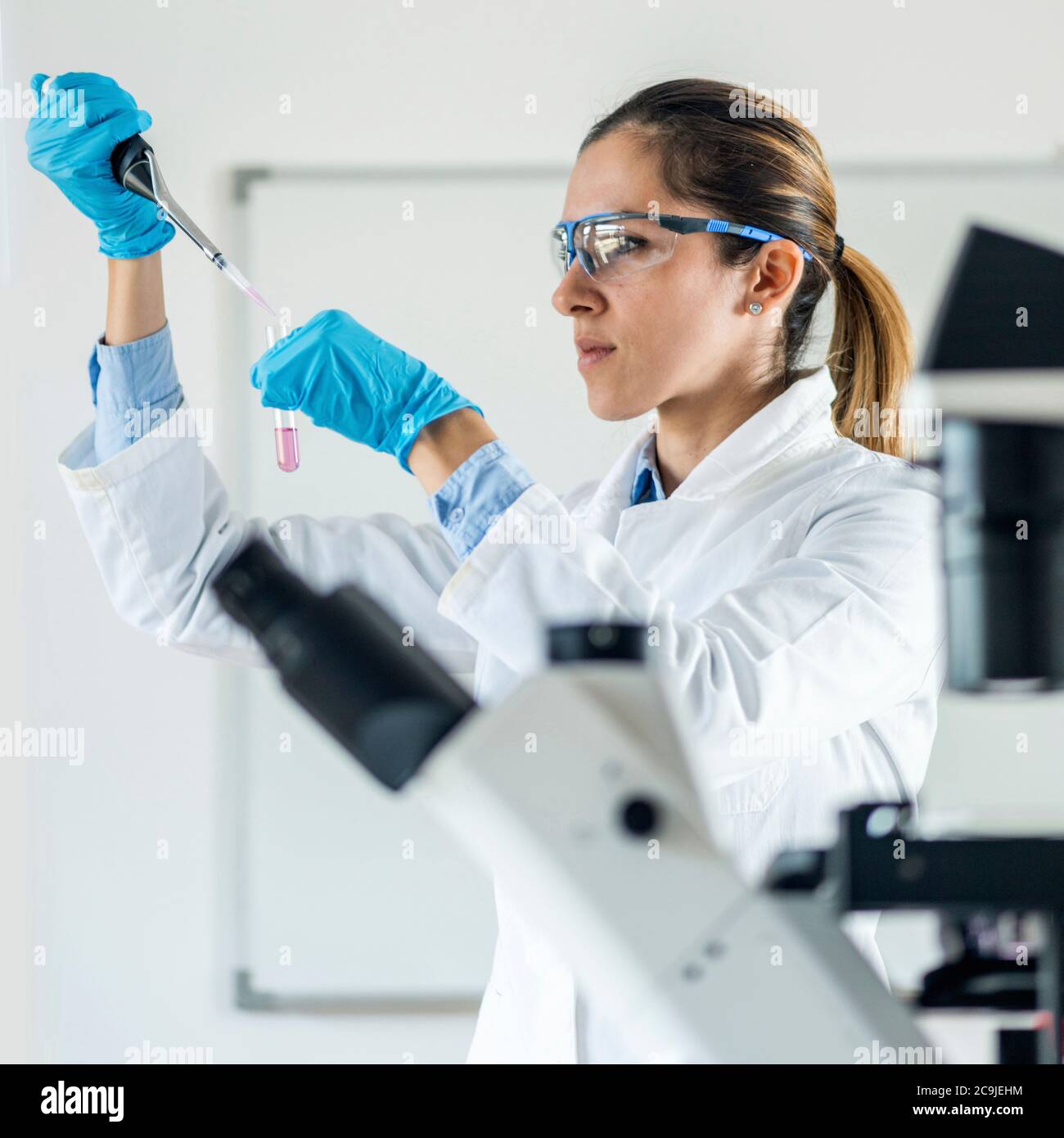 Laboratory technician with micro pipette Stock Photo - Alamy