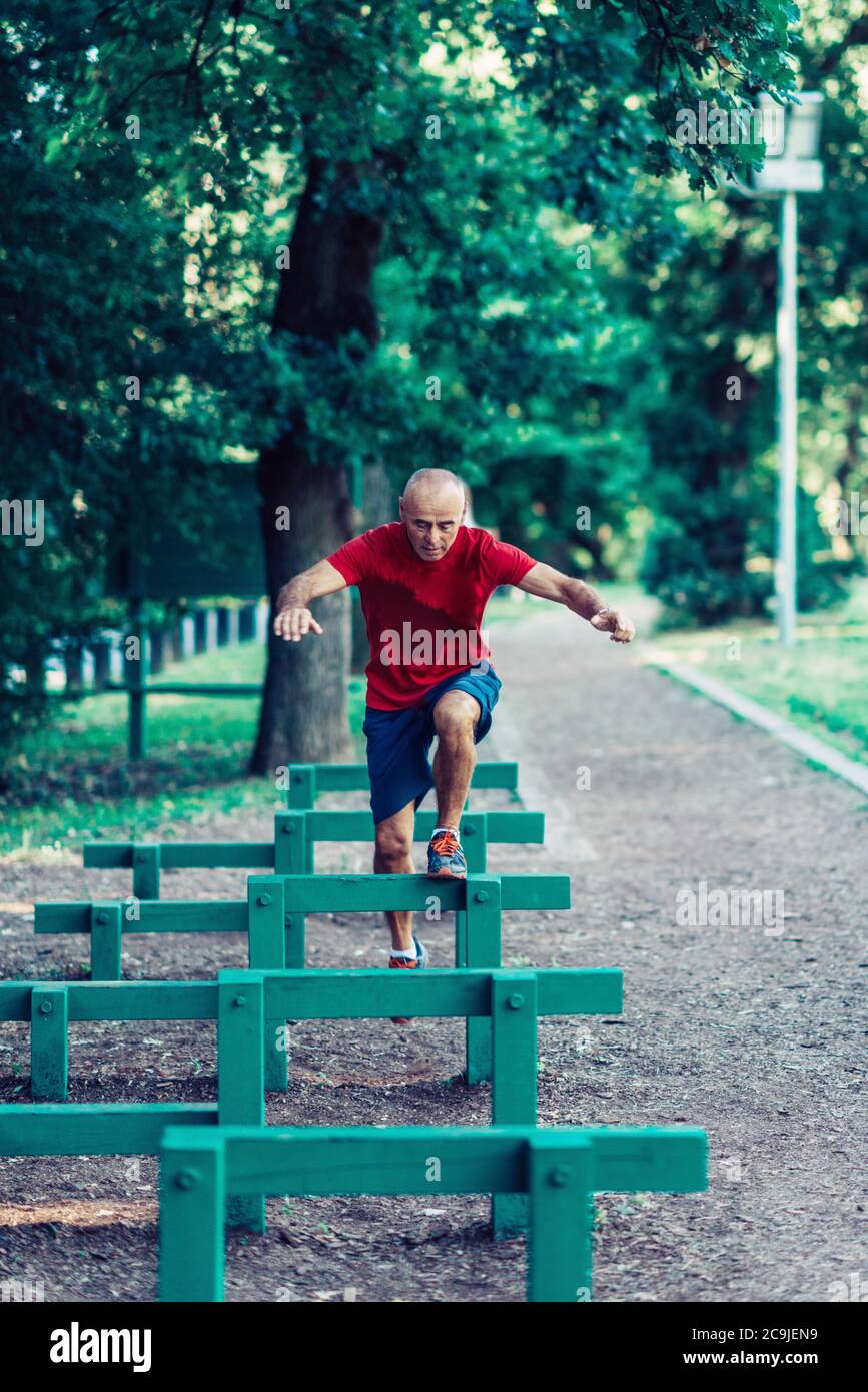 Fit senior man exercising in a park. Stock Photo