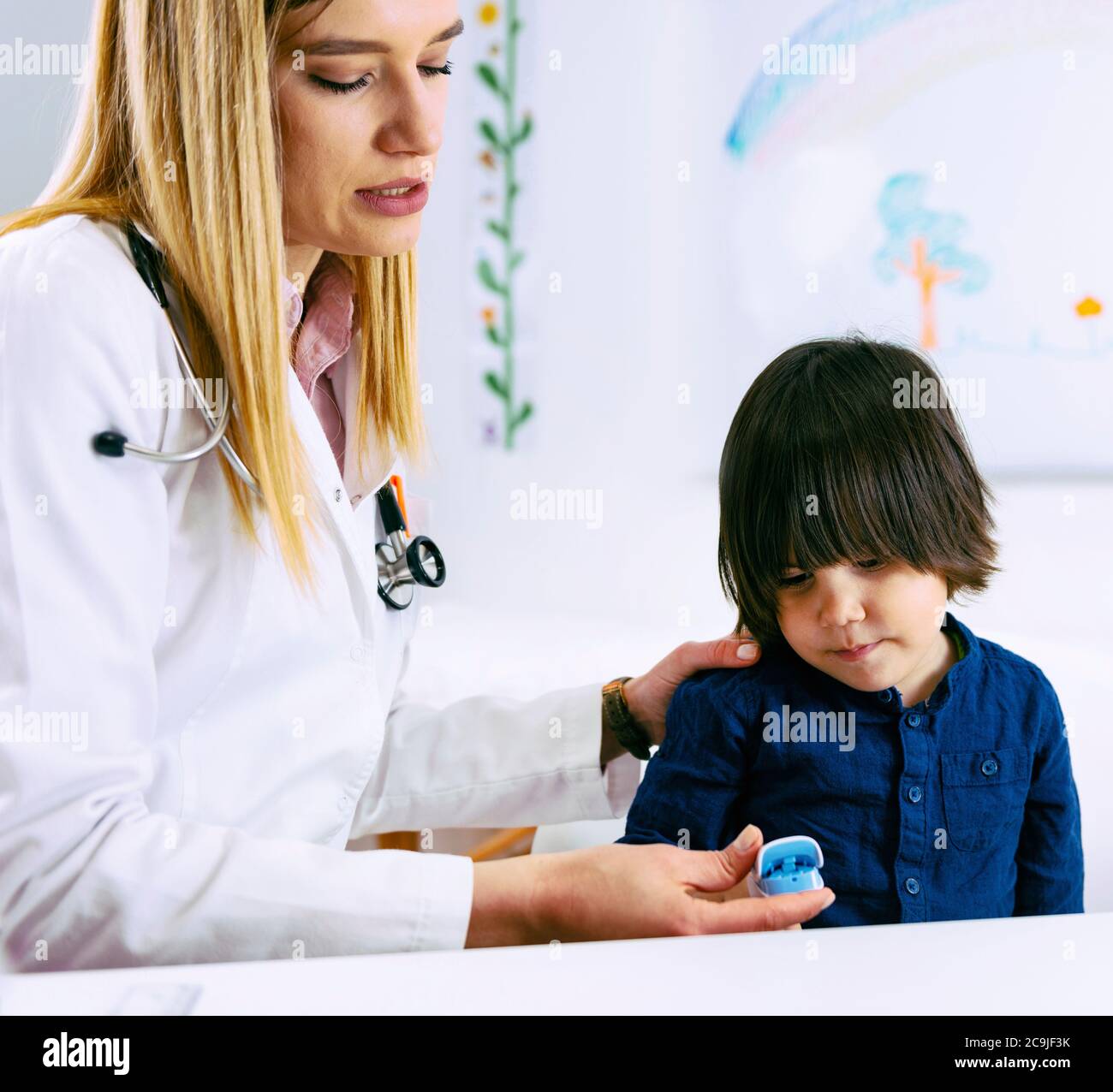 Paediatrician measuring oxygen in the blood and the rhythm of the heart